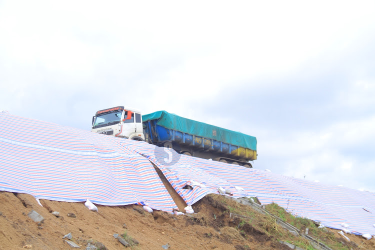 A truck passing on the destroyed service lane along Green Park area in Athi River, Machakos County. It was destroyed by the ongoing heavy rainfalls.