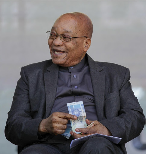 President Jacob Zuma offers a man who came to the edge of the stage money from his pocket as thousands of people gather at Orlando Stadium, Orlando East, Soweto to celebrate Youth Day. The day commemorates those killed on June 16, 1976 in the Soweto Uprising, where some 20,000 school pupils protested peacefully against Afrikaans being the medium of instruction in education. Police opened fire on the protesters killing hundreds. Picture: CORNELL TUKIRI Â© THE TIMES 16 June 2016