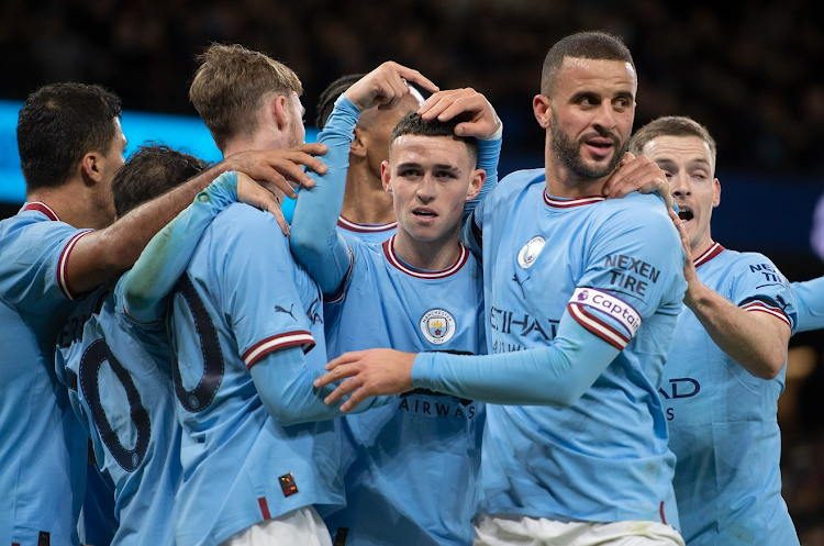 Phil Foden and Kyle Walker of Manchester City celebrate their goal and assist with teammates Rodri, Bernardo Silva, Cole Palmer, Manuel Akanji and Sergio Gomez during the FA Cup third round match agaist Chelsea at Etihad Stadium in Manchester on January 8 2023.