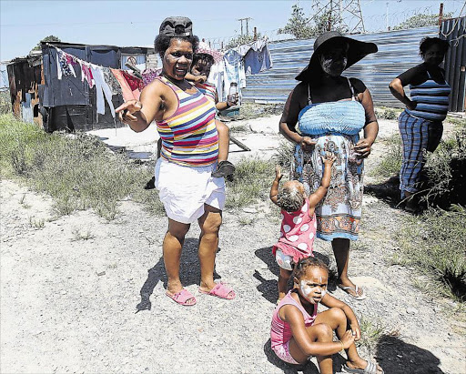 UNHAPPY: A year after residents were told to tear their shacks down as they would be placed in temporary structures, they are now being told to vacate the land Picture: SIBONGILE NGALWA