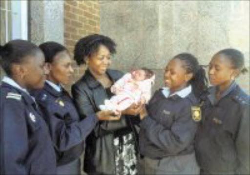IN GOOD HANDS: Policewomen with the five-day-old baby. Pic. Len Kumalo. 06/2008. © Sowetan.