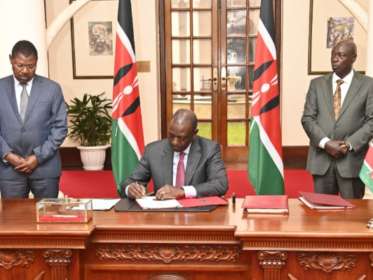 National Assembly speaker Moses Wetangula (left) and Deputy President Rigathi Gachagua look on as President William Ruto sign into the law the supplementary appropriation Bill, 2023 at Statehouse on November 23, 2023.