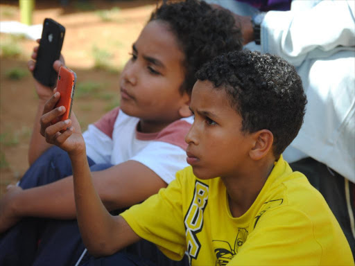 Youth recording proceedings at an event in Malindi using digital phones. The CA has implemented a campaign aimed at educating the public in a bid to protect children while using the internet. Photo/Alphonce Gari