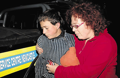 QUIET AND SCARED: Marcel Blandin de Chalain and his mother, Adri, reunited yesterday in Newcastle