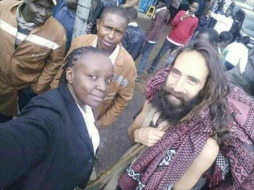 A woman takes a selfie with 'Jesus' after he was spotted along Moi Avenue Wednesday, November 23, 2016. /COURTESY