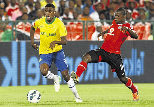 Jabulani Shongwe of Mamelodi Sundowns zooms past Sifiso Myeni of Orlando Pirates in search of an elusive goal during the teams' PSL clash at Loftus stadium, Pretoria, last night. Pirates beat Sundowns 3-1 Picture: SYDNEY SESHIBEDI