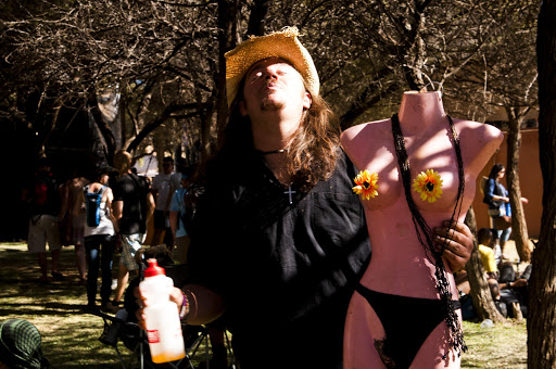 A dude carries his doll around at Oppikoppi Sweet\Thing. Needless to say, he was the butt of many 'headless' jokes.
