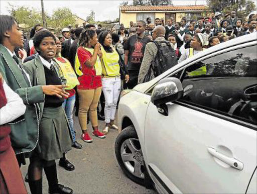 NO WAY OUT: Pupils, fed up with the poor state of their schools, block off the gates to prevent cars from leaving the premises of the department of education in Zwelitsha yesterday Picture: SILUSAPHO NYANDA