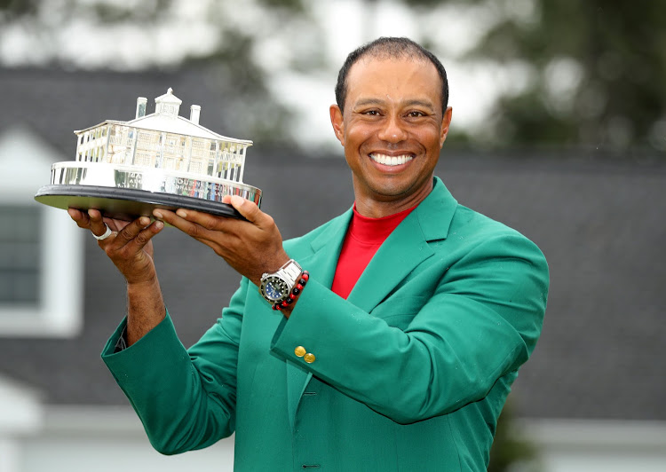 Tiger Woods of the US celebrates with with his green jacket and trophy after winning the Masters at Augusta National Golf Club in Georgia in the US on April 14, 2019.
