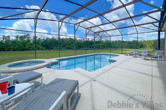 Tranquil southwest-facing pool and spa deck with conservation view at this Davenport vacation villa