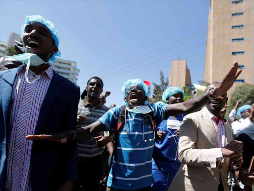 Doctors outside the Employment and Labour Relations Court in Nairobi on January 12. They chanted slogans to demand fulfilment of a 2013 agreement between their union and the government that would raise their pay and improve working conditions /REUTERS