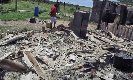 CHARRED REMAINS: The remains of a house that bur nt down yesterday, leaving four people dead Picture: BONGANI FUZILE