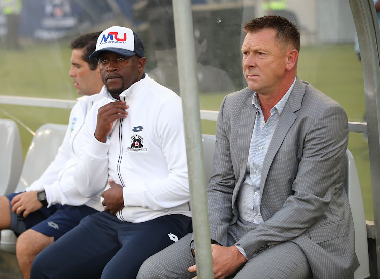 Maritzburg United coach Eric Tinkler and his assistant Vincent Kobola watches on during a match.