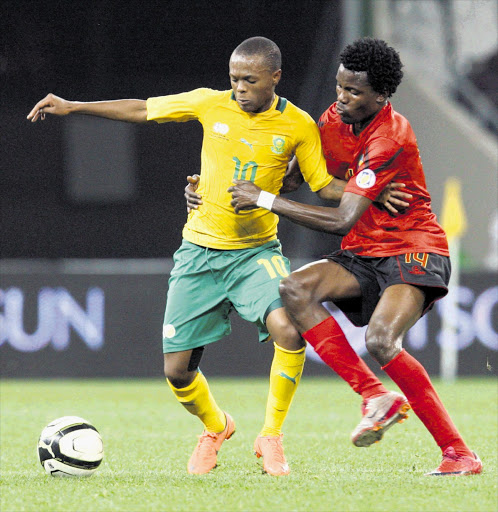 Thulani Serero of Bafana Bafana jostle for possession with Manuel Chiluvane of Mozambique during a friendly international match at Mbombela last night Picture: SYDNEY SESHIBEDI