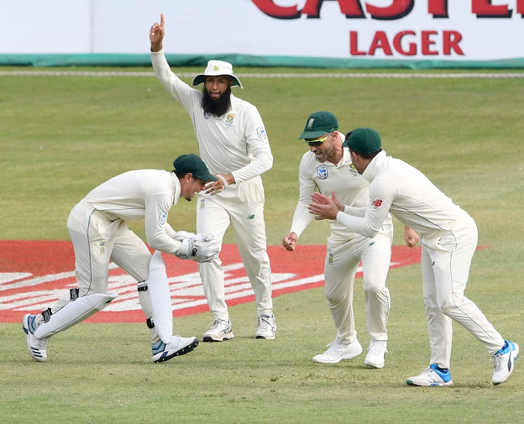 Quinton de Kock takes the catch while Hashim Amla, Faf du Plessis and Dean Elgar of the Proteas appeal for the wicket of Lahiru Thirimanne of Sri Lanka during day 1 of the 1st Test match between South Africa and Sri Lanka at Kingsmead Stadium on February 13, 2019 in Durban, South Africa.
