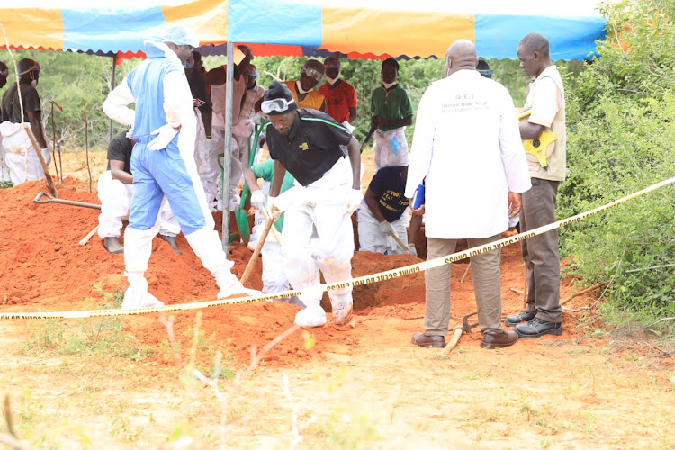 Detectives during the exhumation of bodies in Shakahola Forest.
