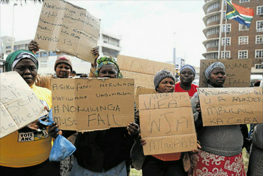 TAKE HER AWAY: Ward 13 residents protest against their ward councillor Nokulunga Matiwane outside the East London City Hall yesterday. Picture: SIBONGILE NGALWA