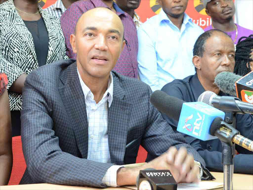 A file photo Nairobi governor aspirant Peter Kenneth, flaked by Jubilee leaders, addressing the press after presenting his nomination papers at Jubilee party offices in Pangani, Nairobi. /VICTOR IMBOTO