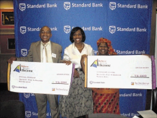 ALL SMILES: Entrepreneur Ezekiel Madigoe, Tina Eboka of Standard Bank, and businesswoman Lemogang Aurelia Lehabe at the Believe-Begin-Become awards ceremony. Pic. Penwell Dlamini. 28/03/2010. © Sowetan.