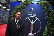 Jude Bellingham poses with the Laureus trophy and wreath on the red carpet during the Laureus World Sports Awards at Galería De Cristal in Madrid, Spain on Monday.  