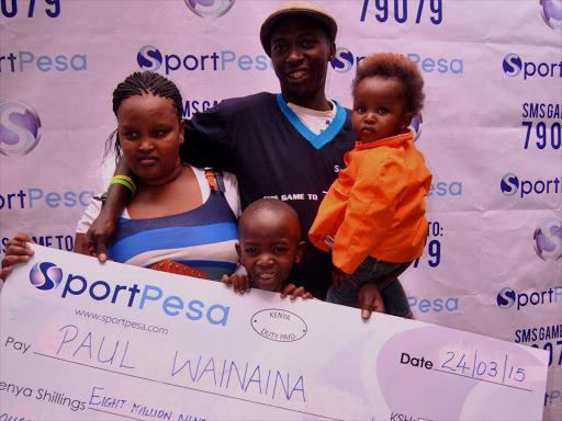 Paul Wainaina join by his family Nancy Wanjiru (wife), Hellen Wanjiru daughter and John Nganga son after winning Sportspesa Shs 8 million. Photo Collins Kweyu