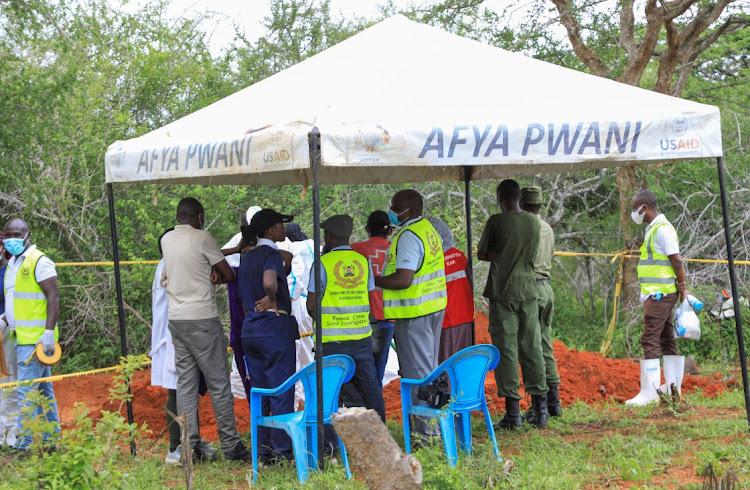 Forensic experts and homicide detectives from the Directorate of Criminal Investigations (DCI), gather to exhume bodies of suspected followers of a Christian cult named as "Good News International Church", who believed they would go to heaven if they starved themselves to death, in Shakahola forest of Kilifi county, Kenya May 9, 2023.