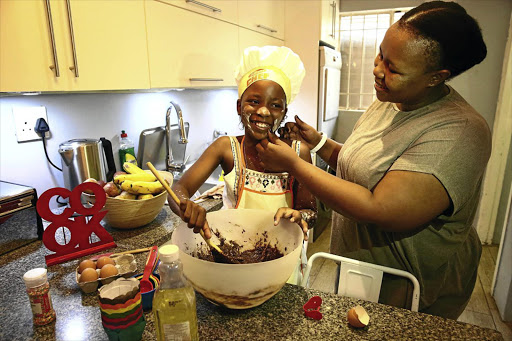 Kuhle Ntsele and her mother Mamello have fun in the kitchen.