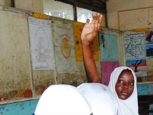 Muslim pupils wearing hijab during an English lesson at Central Girls Primary School on 4th May 2015./Andrew Kasuku