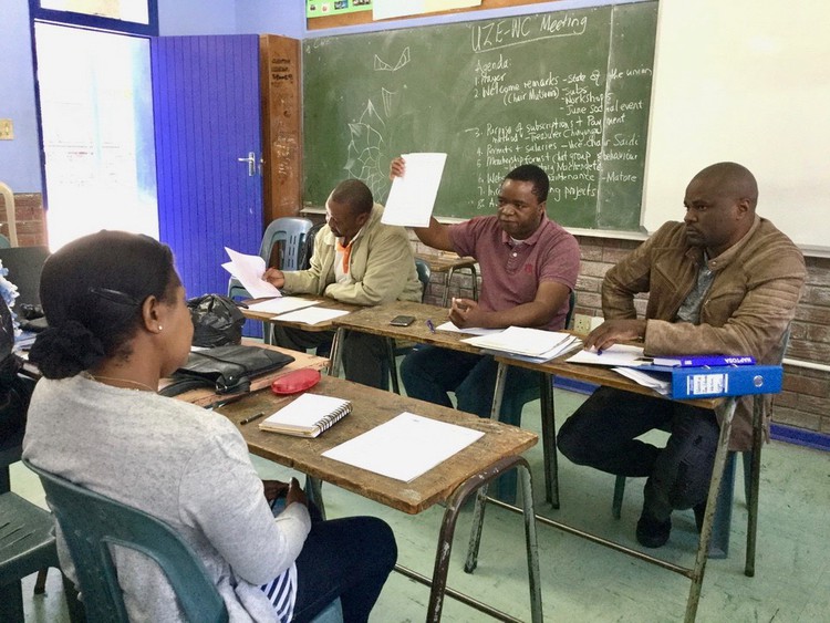 Chairperson Jack Mutsvairome (centre), with publicity secretary Kudzi Muchengete (on his right) and vice-chairperson Ibrahim Saidi (on his left) addresses a meeting of the Union of Zimbabwean Educators Western Cape in Parow.