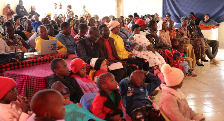 An audience follows the screening of 'No One Leaves Home' in Kawangware