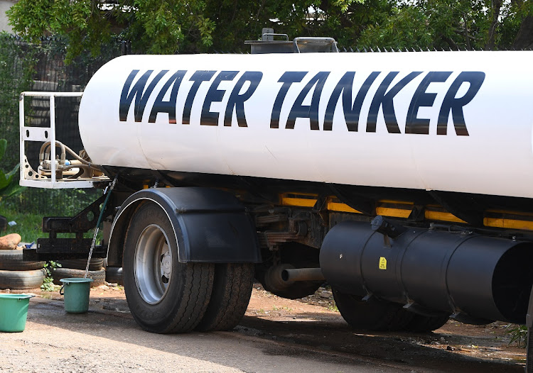 Water is poured from a water tanker into a bucket in this file photo. Picture: LEFTY SHIVAMBU/GALLO IMAGES