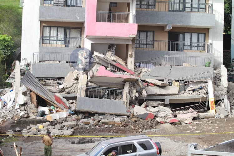 Police officers mark the scene of a collapsed five-storey building at Uthiru, Nairobi on May 8, 2024.