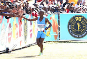 Gift Kelehe greets the spectators during the Comrades Marathon on May 31, 2015 in Durban, South Africa. The 2015 Comrades Marathon is starting at City Hall, Durban and finishing in Pietermaritzburg, South Africa.