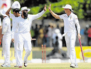 HIGH FIVES: Proteas captain Hashim Amla, centre, celebrates with team-mate Dale Steyn after the team's victory in the opening Test match against Sri Lanka at the Galle International Cricket Stadium yesterday. South Africa won the Test by 153 runs on the fifth and final day