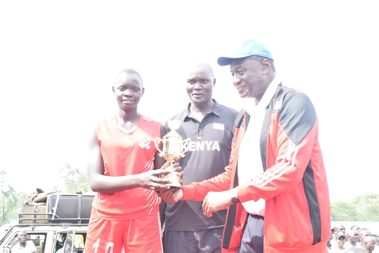 Kesogon captain receiving a trophy from KVF President Charles Nyaberi in Malaba n Sunday.