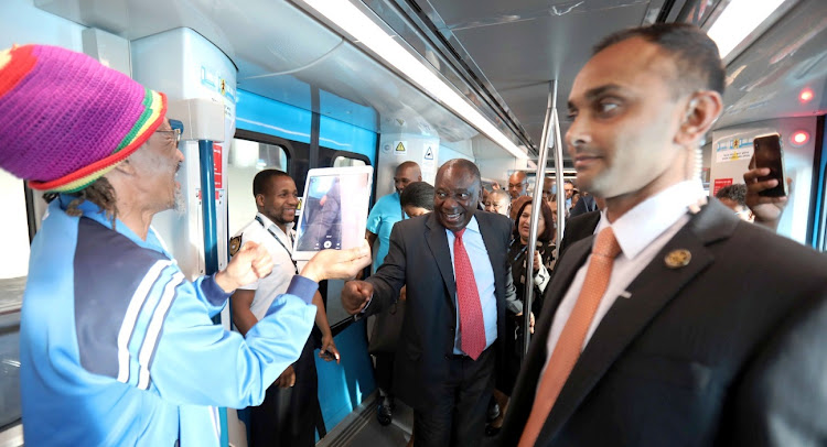 A Cape Town commuter photographs President Cyril Ramaphosa on the journey to Mowbray aboard the first of Prasa's new trains on April 9 2019