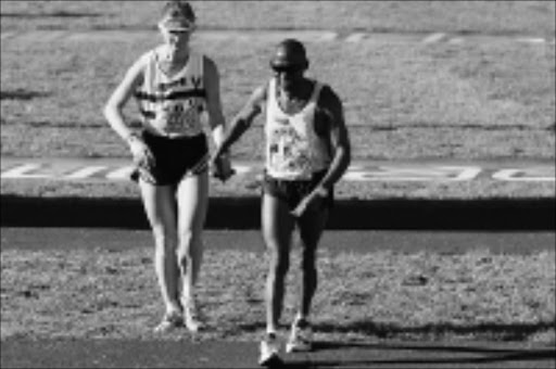 17 June 2002, Comrades Marathon, Durban to Pietermaritzburg, South AfricaKim Pain & Mbuti Mkhwanazi at the finishPhoto Credit:©Tertius Pickard/Gallo Images