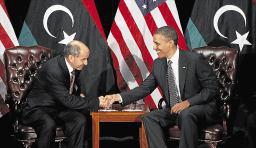 US President Barack Obama with the chairman of Libya's Transitional National Council, Mustafa Abdel Jalil, at the UN, in New York, yesterday, after the AU's delayed recognition of the council as the legitimate post-Gaddafi leadership.