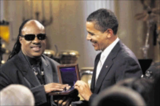 President Barack Obama presents Stevie Wonder with the Library of Congress Gershwin Award during 'Stevie Wonder In Performance at the White House: The Library of Congress Gershwin Prize' in the East Room of the White House in Washington, Wednesday, Feb. 25, 2009. (AP Photo/Gerald Herbert)