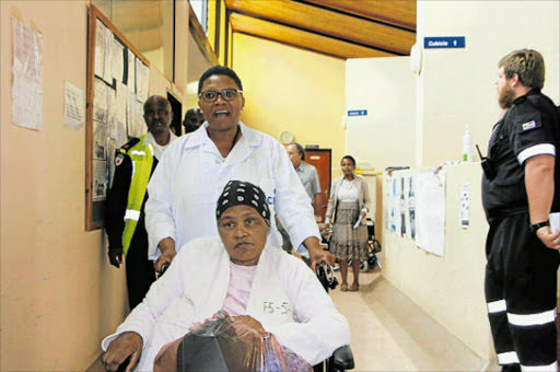 IMPROVED SERVICE: Dr Bongiwe Yose-Xasa wheeling out surgical patient Bulelwa Tiniso as she was being moved to the new building. Picture: BHONGO JACOB