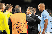 Manchester City manager Roberto Mancini protests to referee Peter Rasmussen after City were denied a penalty at the end of the Champions League Group D match against Ajax Amsterdam at the Etihad stadium on Tuesday. The game ended in a 2-2 draw