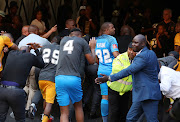 Angry Chiefs fans throwing objects to Steve Komphela, coach of Kaizer Chiefs and players leaving the field during the Absa Premiership 2017/18 match between Kaizer Chiefs and Chippa United at FNB Stadium, Johannesburg on 07 April 2018.