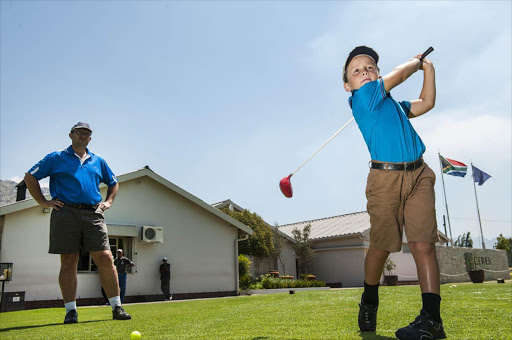 André van der Berg watches his son Wilan, 7, as he perfects his swing on the Ceres golf course. Wilan, who takes lessons at a golf academy, beats his father on handicap.