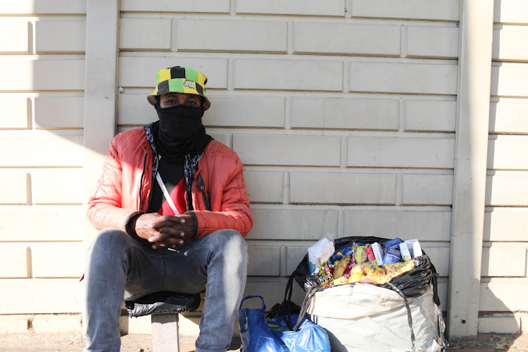 Street vendor Israel Bhaku poses for a picture in Rosebank, Johannesburg.