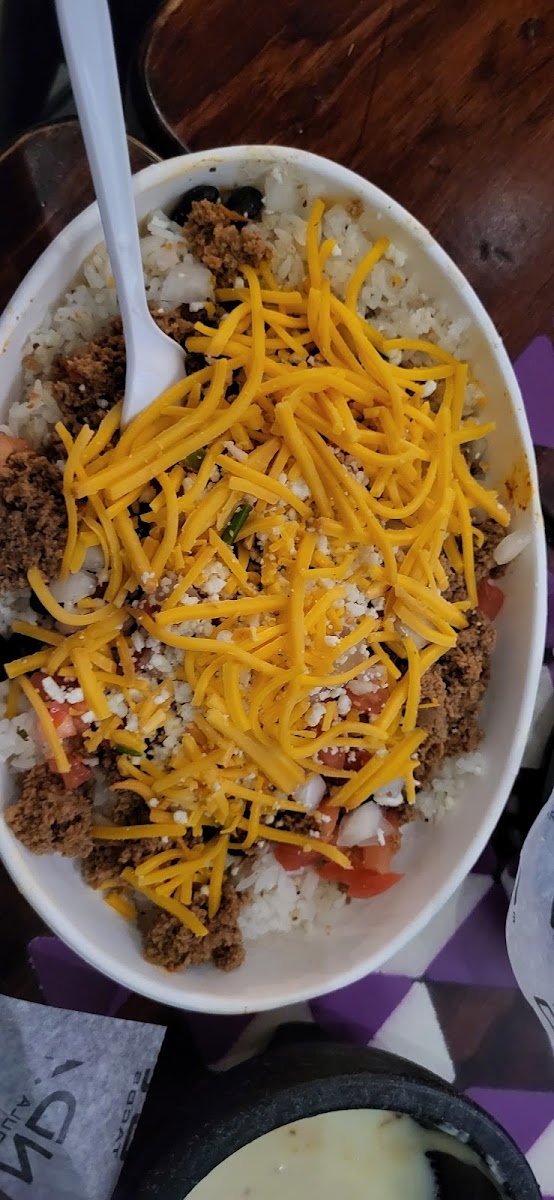 Bowl with rice and beans, gr beef, cilanto & onion, tomato, cotija and cheddar cheese, avocado ranch on the side (forgot a salsa!)