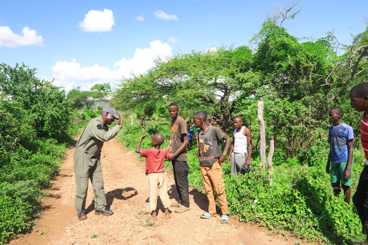 Five-year-old Mutuku Kioko embraced by his family upon being saved by the NPS after he was marooned by floods at Nduani in Yatta, Machakos County on April 23, 2024.
