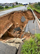 A section of the road at a bridge has collapsed.