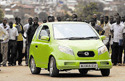 Visitors admire the Kiira EV car made by Makerere University students, which was on display before a test drive in Uganda's capital, Kampala.