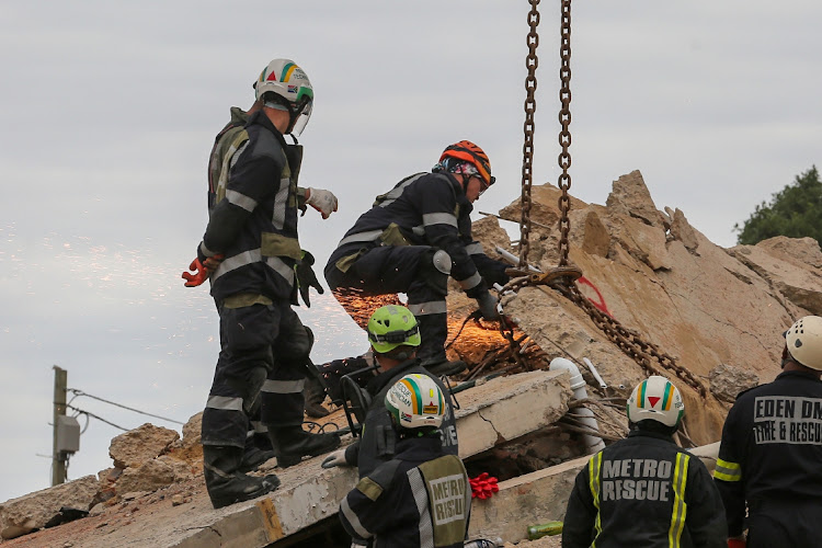 Rescue workers are continuing to scour the rubble of the collapsed building in Victoria Street, George.