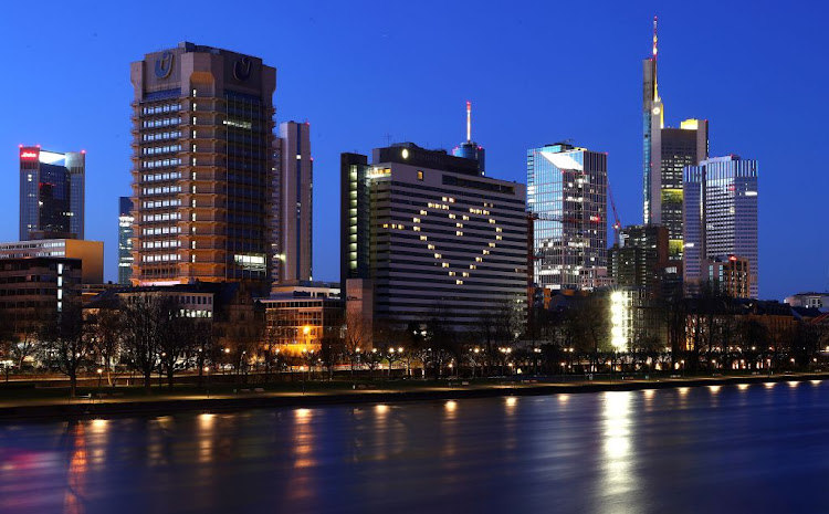 The window lights of a hotel are illuminated in the shape of a heart after German Chancellor Angela Merkel addressed the nation on the consequences of the spread of Covid-19 in Frankfurt, Germany, on March 22 2020.